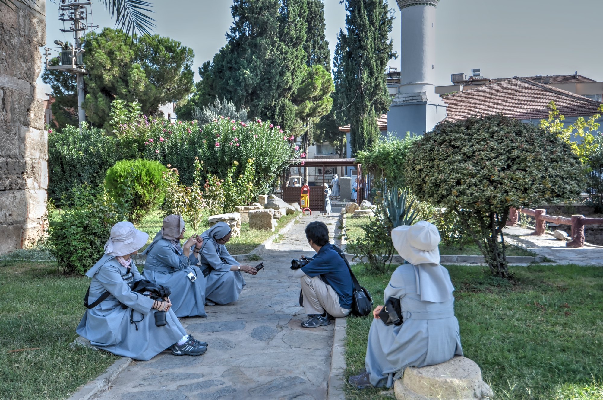 A group of polgrims sitting near the ruins of the Basilica of St John in Alaşehir A group of polgrims sitting near the ruins of the Basilica of St John in Alaşehir