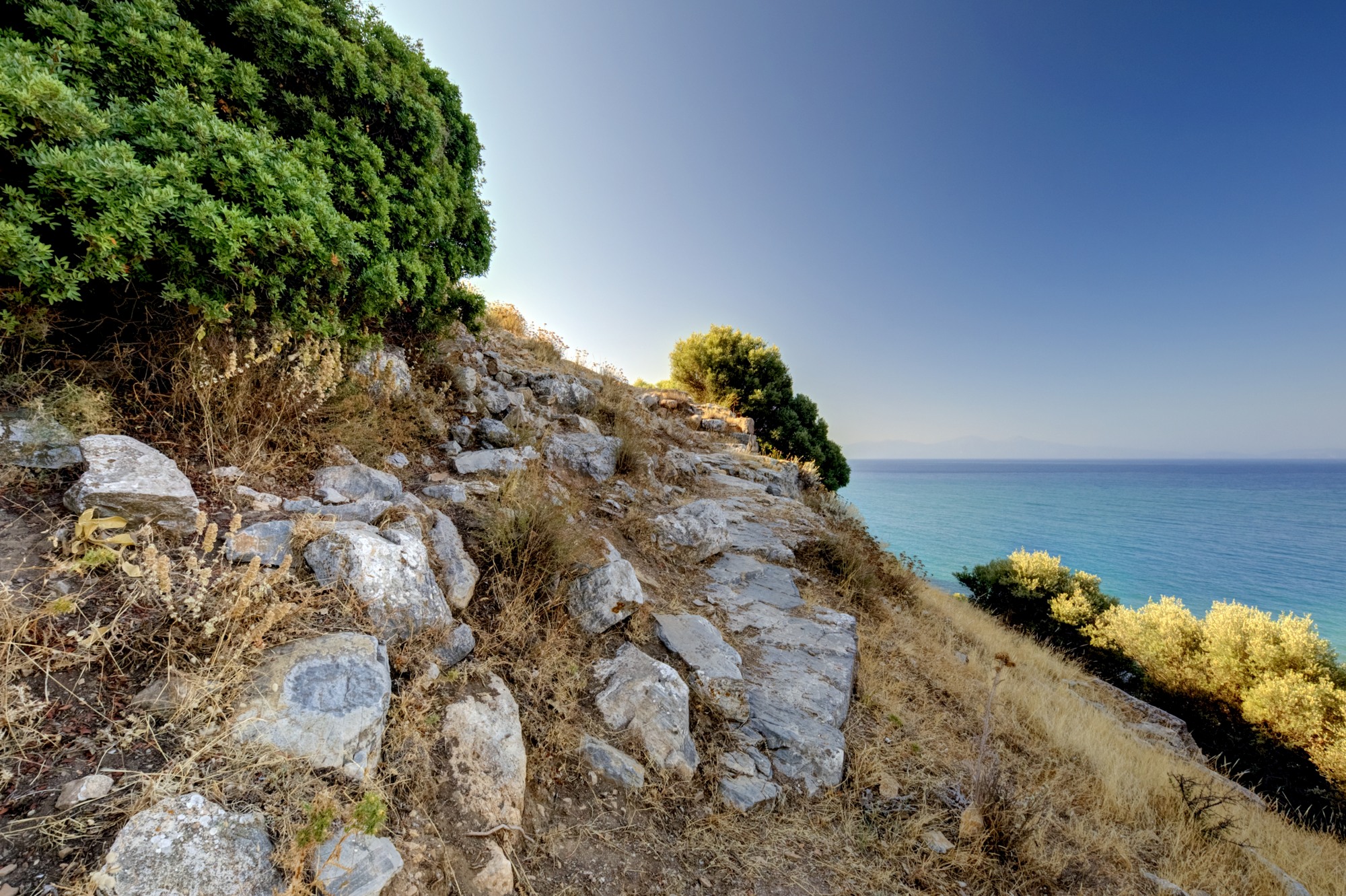 The stony path up the western hill of Notion with the view of the Aegean Sea, July 2025
